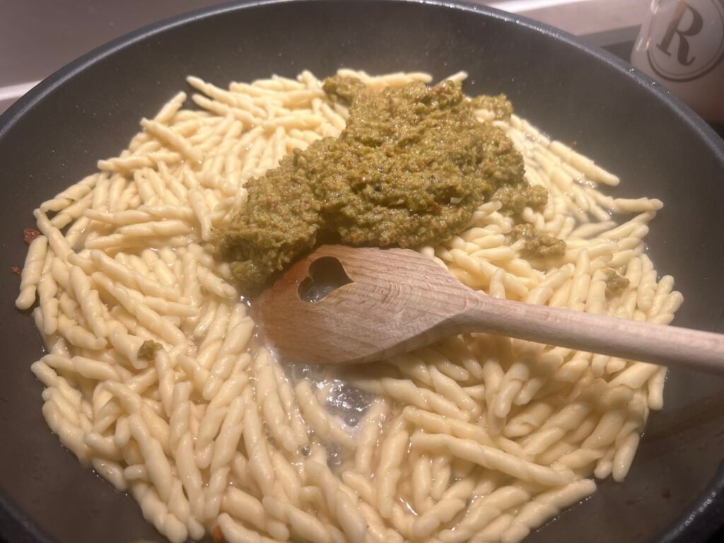 Trofie werden mit grünem Pesto vermengt